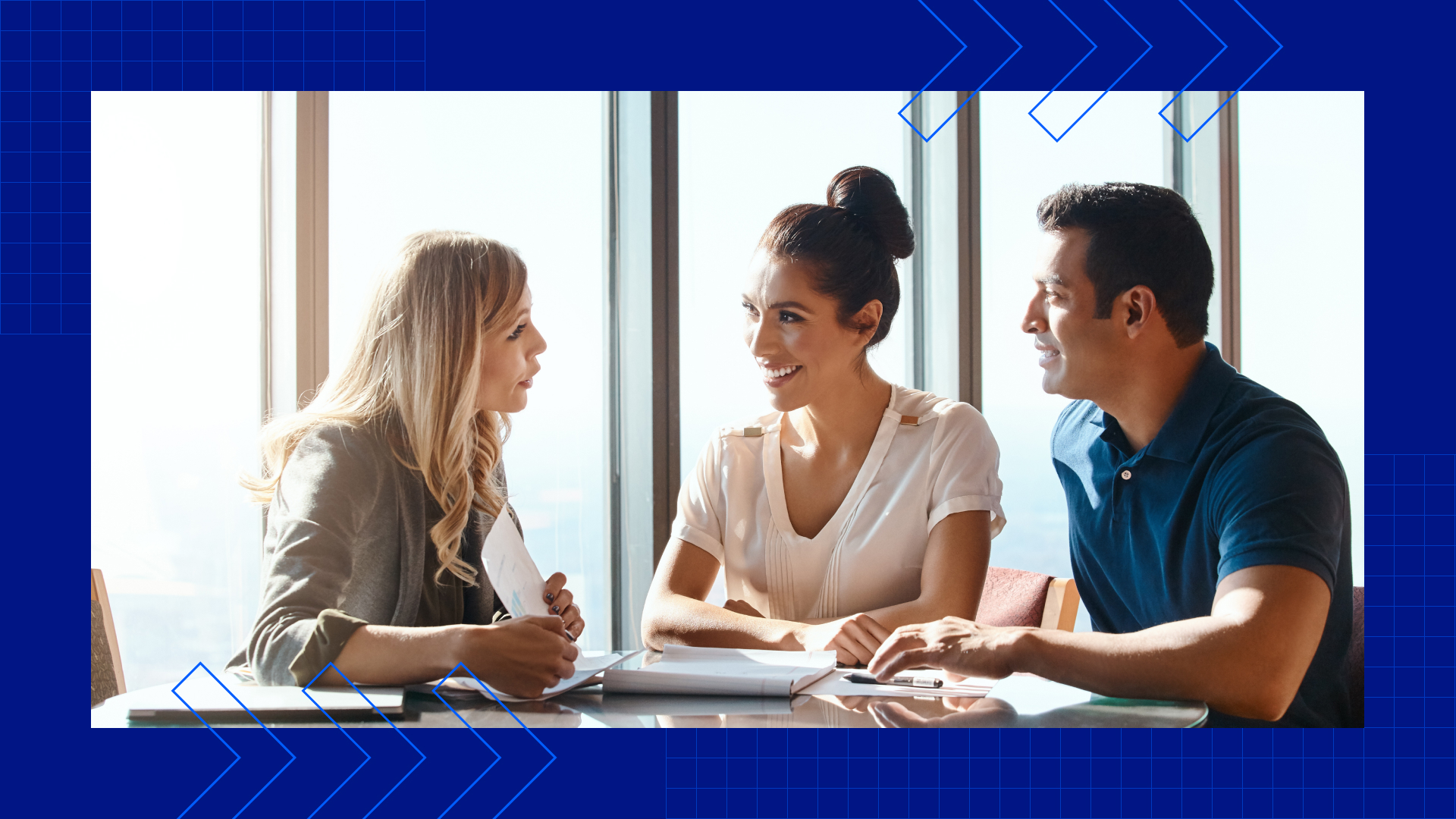 A man and woman meeting with their life insurance agent at a table in their house.